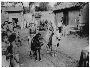 Two soldiers on horses in a village (part of Michael Lindsay's escort), Central Hebei province