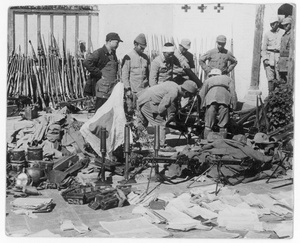 Chinese and Japanese soldiers, with weapons, uniforms, documents and a flag captured from the Japanese
