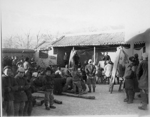 Crowd gathered for a drama performance, listening to a story