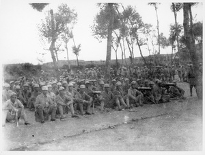 Eighth Route Army soldiers sitting on the ground with machine guns