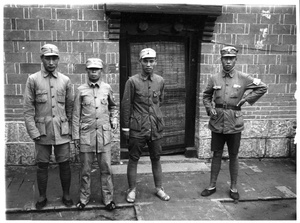 Four Chinese soldiers by a door