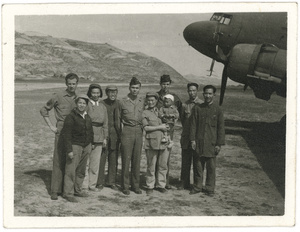 Hsiao Li Lindsay (李效黎) and baby Erica Lindsay, with others, beside a Douglas C-47 Skytrain, after the arrival at Yan'an (延安) of the U.S. Army Observers Section, 1944