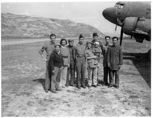 Hsiao Li Lindsay (李效黎) and baby Erica Lindsay, with others, beside a Douglas C-47 Skytrain, after the arrival at Yan'an (延安) of the U.S. Army Observers Section, 1944