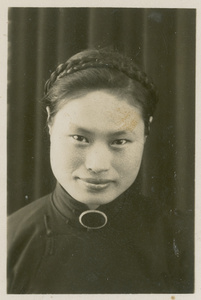 A portrait of Hsiao Li Lindsay (李效黎), with braided hair