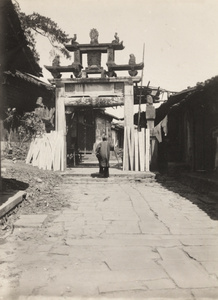 A woman walking toward a pailou, Yongchun