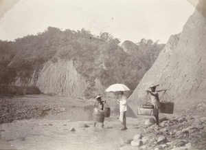 Dr James Laidlaw Maxwell and porters crossing a river, near Baksa, Taiwan