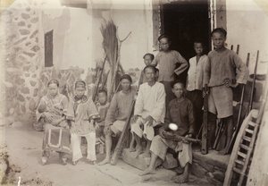 Family with tiger shooting guns and agricultural tools, near Toa Bo mountain, Zhangpu