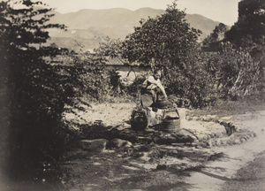 A woman drawing water from a well, Fujian province
