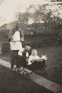 An amah with the Logan Roots children in a pram