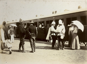 Soldiers and civilians at a railway station