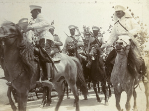 Mounted allied forces riding past sandbags, Tientsin