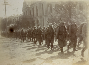 Allied troops marching in a street