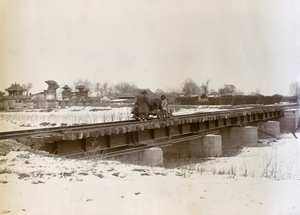 Railway bridge, with ruins in background, Peking