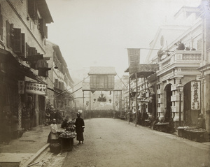 Fruit pedlars and crowds on a decorated Queen's Road, Hong Kong 