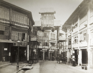 Street with decorated gateway and Chinese shops, Hong Kong