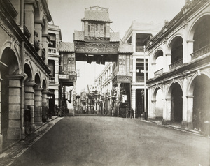 A decorated Chinese gateway in the middle of the road, with European style arches on both sides, Hong Kong