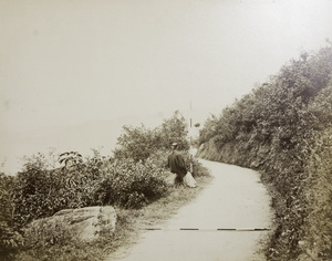 A Chinese man sitting by the roadside, Hong Kong