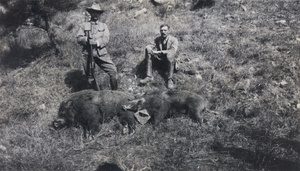 huntsmen with two dead wild boar