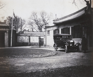 Driver and car in front of compound