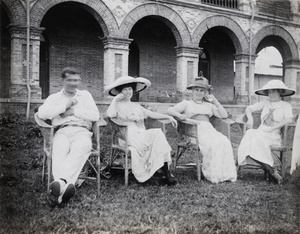 Oliver Heywood Hulme and three women sitting in a garden