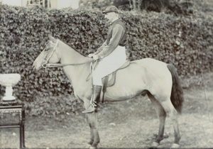 J.C. Oswald on a horse, with trophy