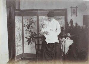 Woman, baby and Chinese screen