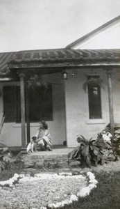 A woman and a dog on a veranda, Caretaker’s House, Pinewood Battery, Hong Kong