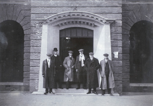 Six men by the entrance to Gordon Road Police Station, Shanghai