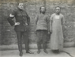 Harold Peck with handcuffed men, Shanghai
