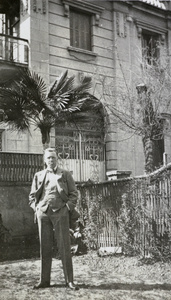 Harold Edwards Peck in front of a house