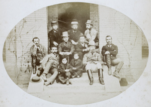 A group of nine men and two boys, on steps
