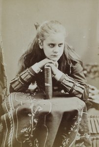 A portrait of an unidentified girl, with a book