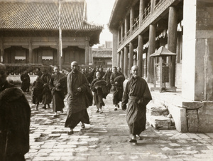 Lama priests and a prayer wheel, Yonghe Lamasery, Beijing