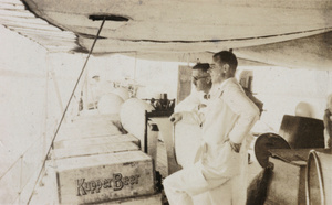 British diplomatic service staff with crates of Kupper Beer, on HMS Suffolk