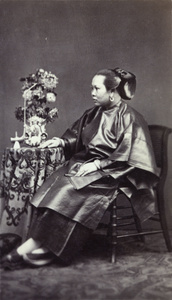 Portrait of a woman, with pipe and a vase of flowers