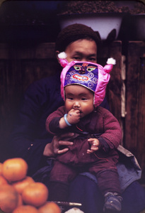 Boy with silk animal face hat, Kunming, 1945