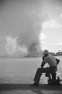 Sikh man looking over Huangpu towards fires in Pudong, Shanghai