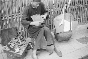 Shoemaker at work in the street, Shanghai