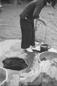 Woman drawing water from a well, Shanghai