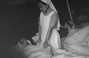 Nurse and patient in a ospital ward, Shanghai