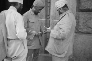 Sikhs, with banknotes and coins, Shanghai