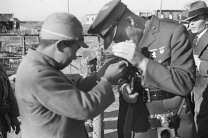 Japanese soldier lighting cigarette of American officer, Jessfield Railway Bridge, Shanghai