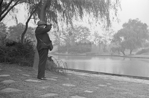 Civilian warden in a park, with binoculars, Shanghai