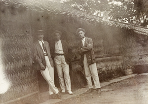 Kay, Sullivan and Colter by a bamboo house