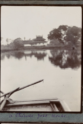A waterside temple and part of a boat