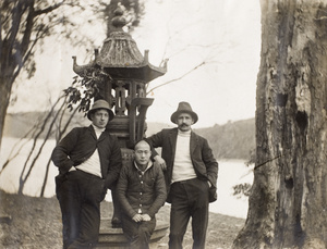Three men and an incense burner by a river