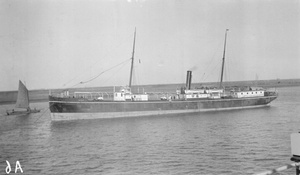 The steamer 'Hoihow I' with a junk