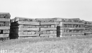 Stacks of cut timber (railway sleepers?) on a loading berth