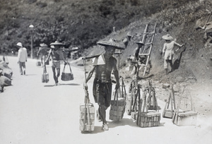 Construction workers carrying bricks, forty at a time, Hong Kong