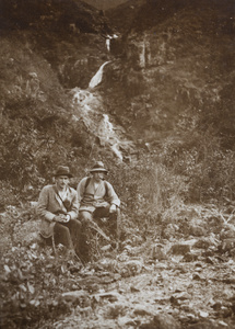 Two men sitting by a waterfall near Tai O (大澳), Lantau Island (大嶼山), Hong Kong